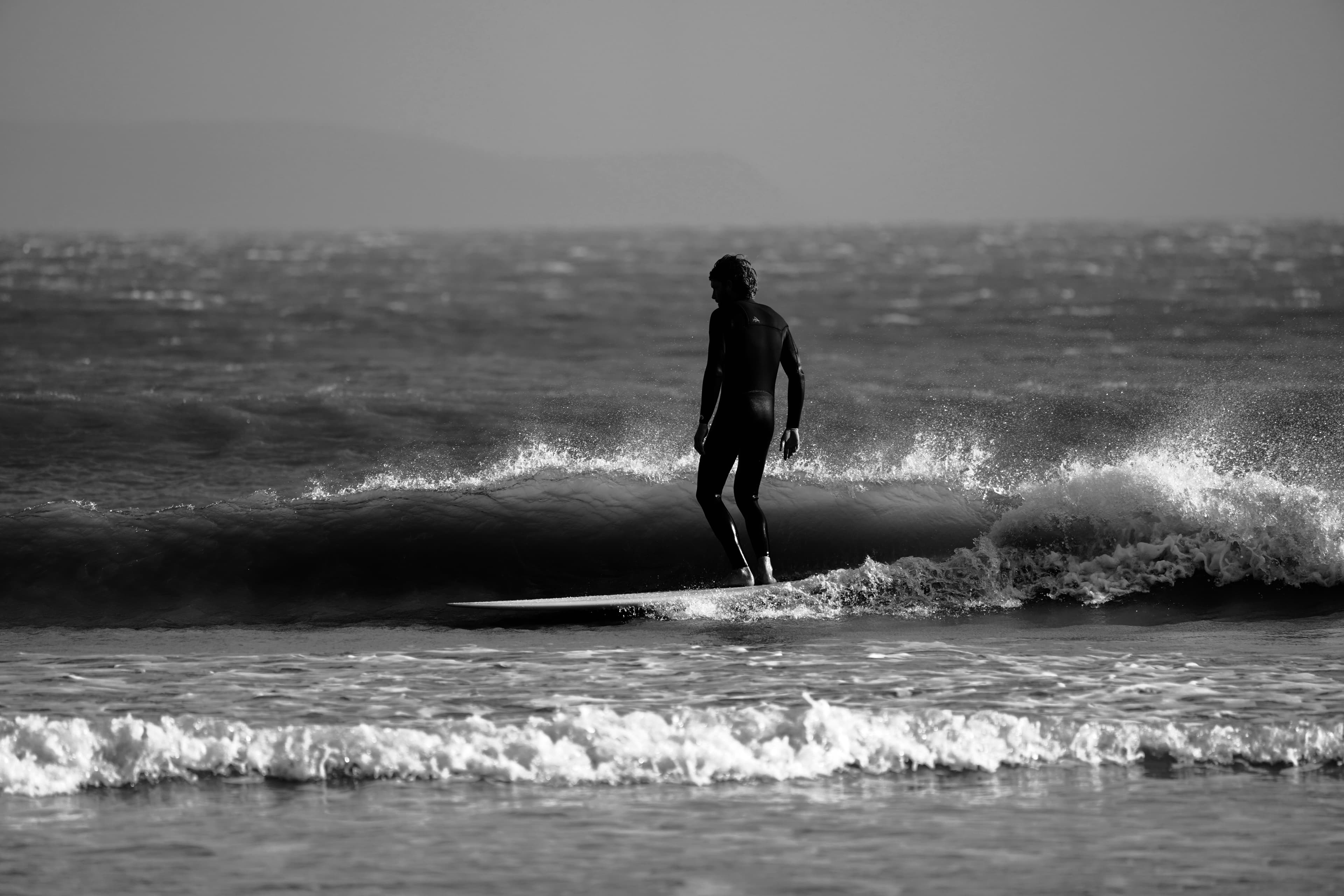 A longboarder noseriding a clean wave at Cap Sim