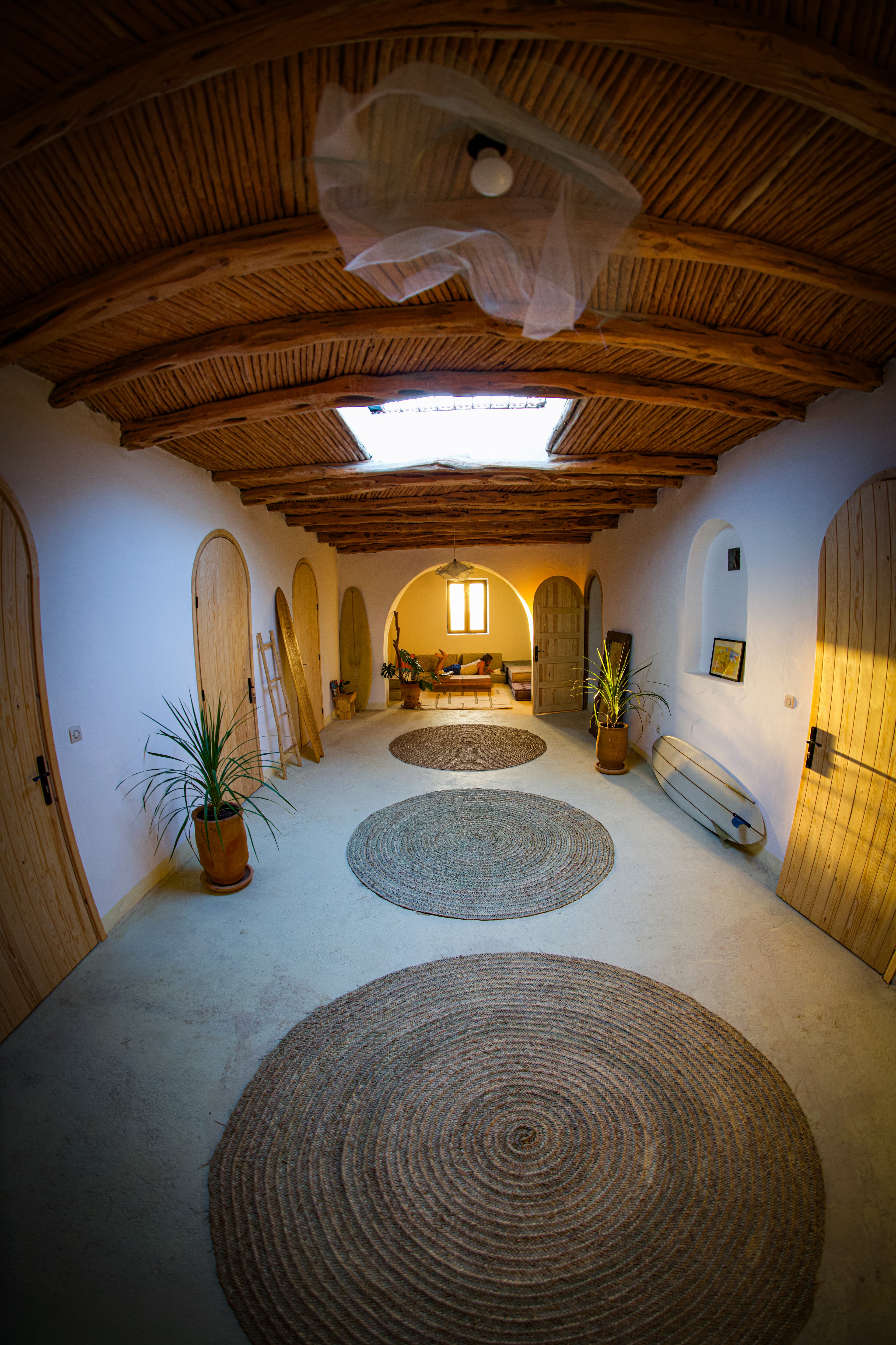 The vaulted corridor at Dar Gamila, boards and doors along the walls