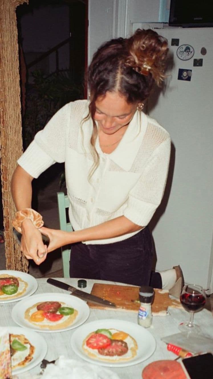 Sarah Passador plating a shared meal in the kitchen